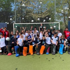 Children throwing hockey balls into the air