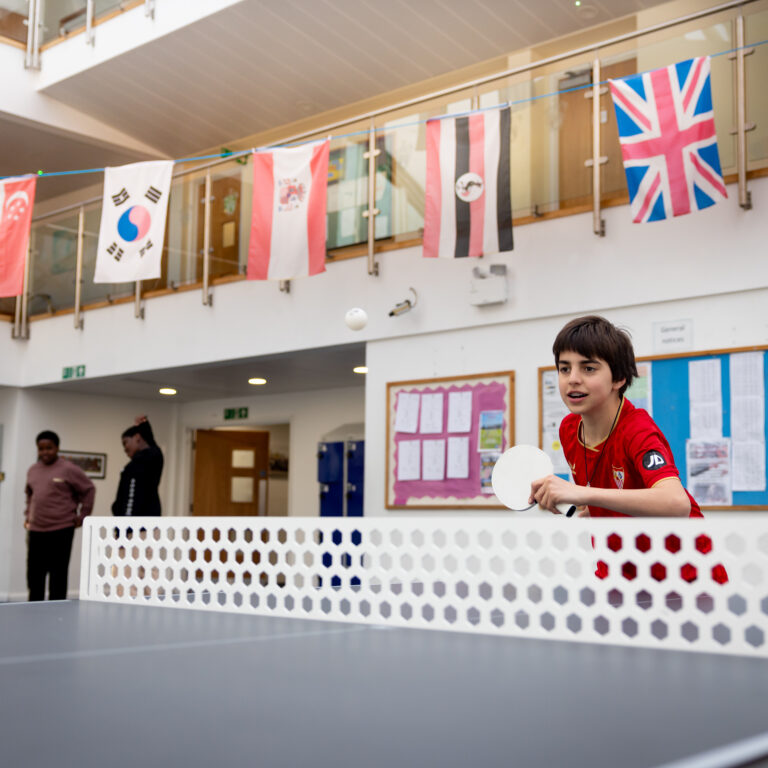 Junior boarder playing table tennis
