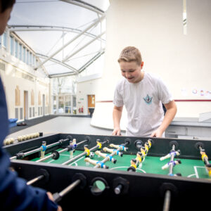 Junior boarders playing table football