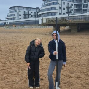 Two students with measuring stick on Ramsgate Beach