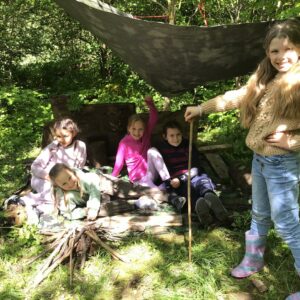 Year 4 girls in shelter in forest