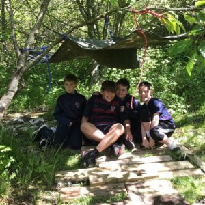 Year 4 boys under shelter in forest