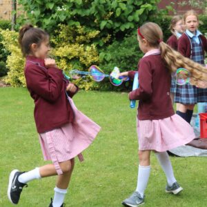 School girls playing with bubbles