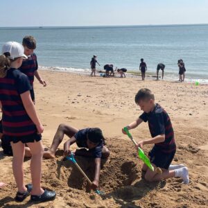 School children building sandcastles