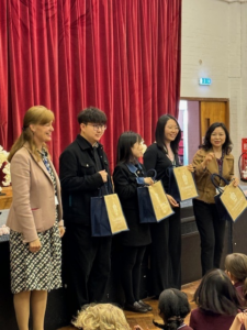 Chaoyang school teachers with gift bags on Stage