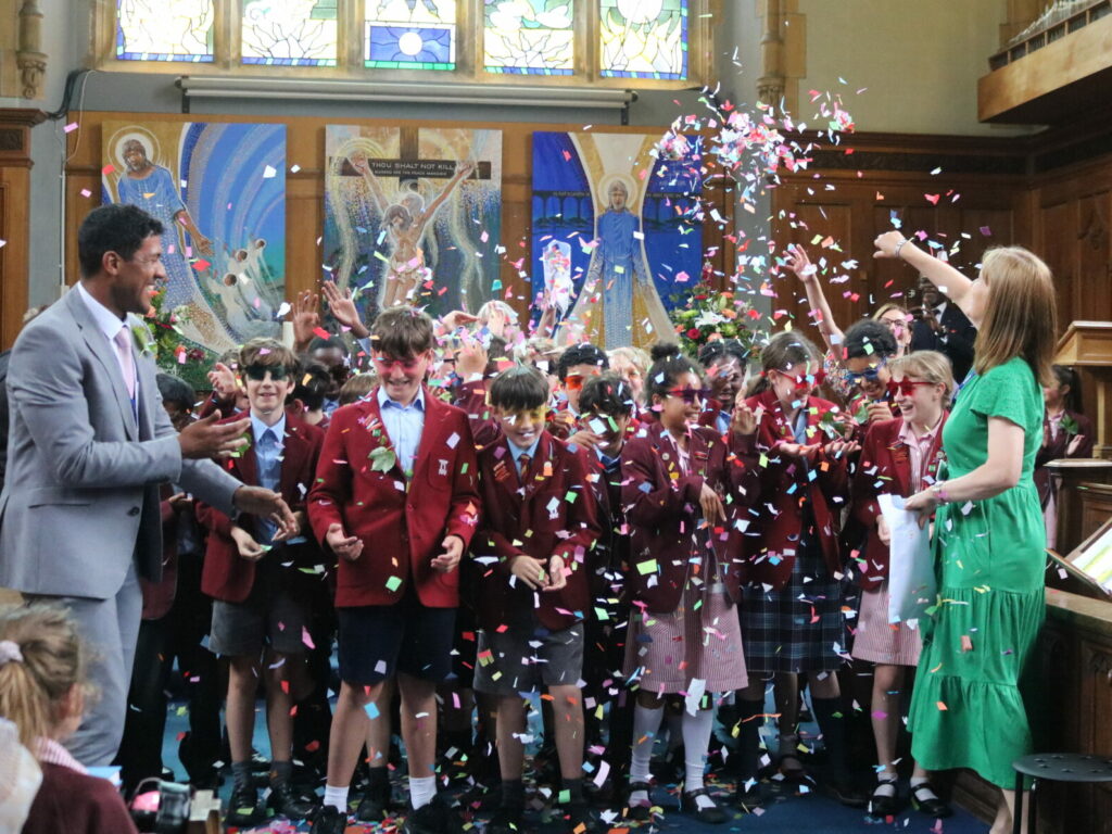 school children covered in confetti