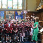 school children covered in confetti