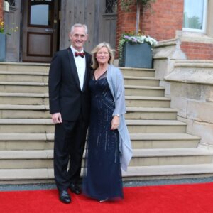 Couple in black tie and dress on red carpet