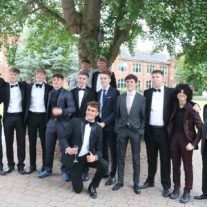 Group of boy students at black tie event under a tree