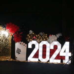 2024 sign with playing cards and balloons