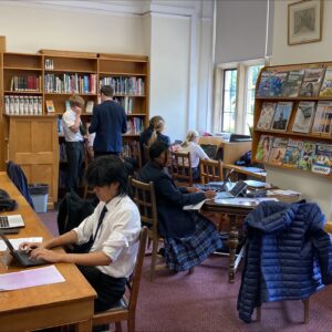 Students in school library working on newspaper