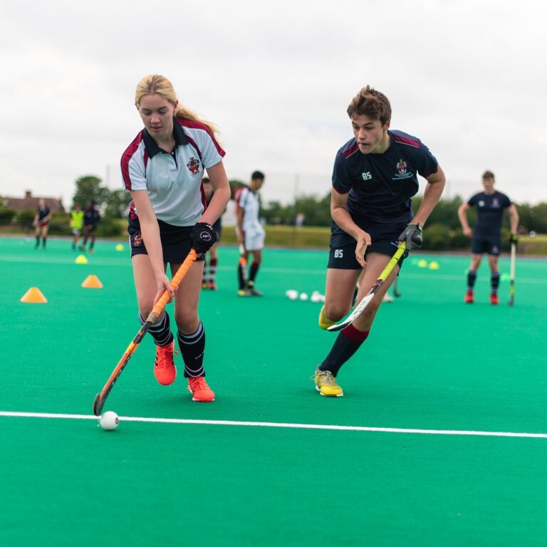 boy and girl playing hockey