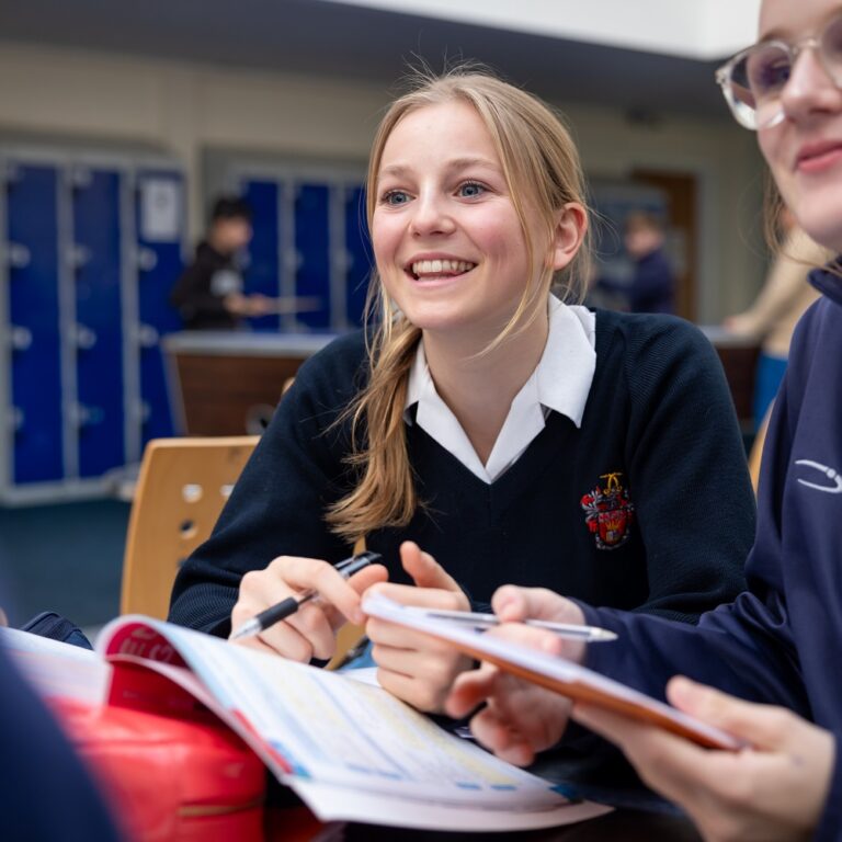 Girl in uniform holding pen