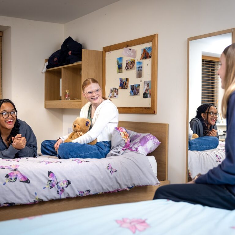 3 girls talking in boarding bedroom