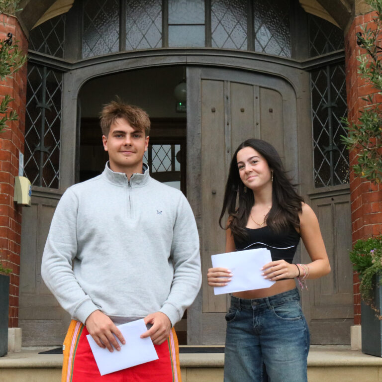 Boy and girl outside door with results