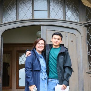 Mum and son in front of door