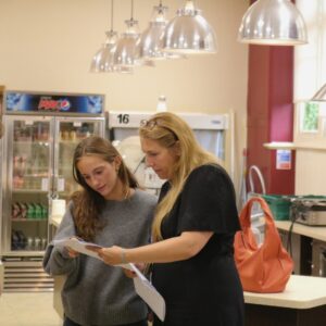 Girl and teacher looking at results