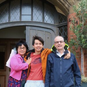 family standing on front of door