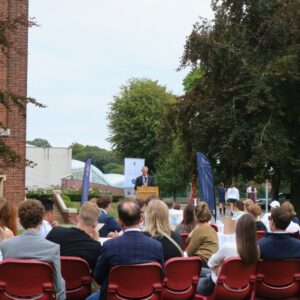 man with microphone on podium