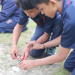 boys lighting cotton wool with flint and steel