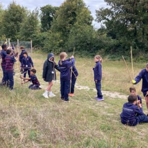 students building shelter from wooden sticks