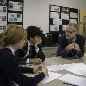 teacher working with senior school students